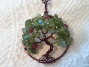 65th Birthday gift from Dave. A peridot and copper tree, my birthstone, with ruby (Jade's) and aquamarine (John's).