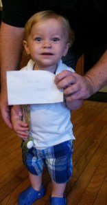 Dad helped Jaxton hold the greeting.